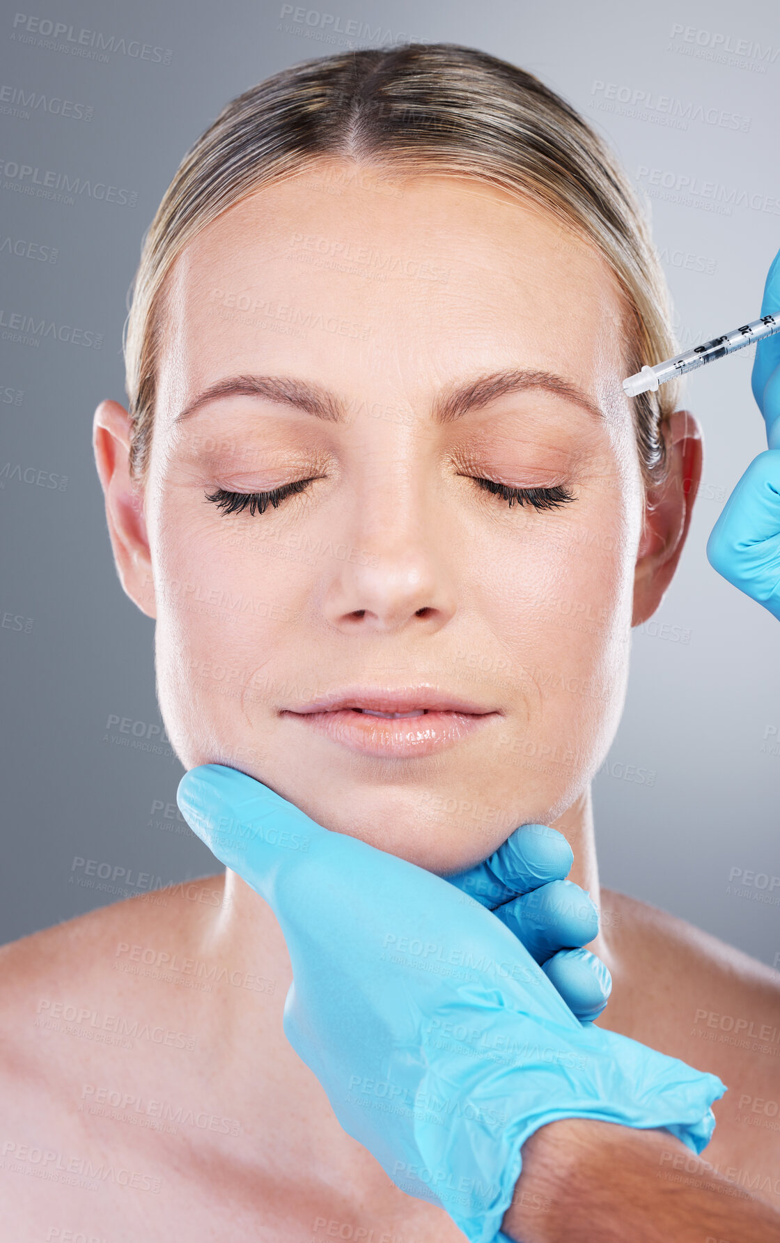 Buy stock photo Face, woman and hands in studio with needle, medicine and collagen filler for facial treatment. Dermatology, female person and doctor with injection for numb skin, plastic surgery and gray background