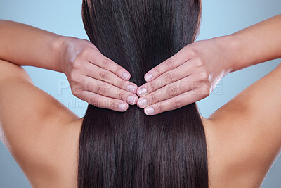 Buy stock photo Beauty salon, hair and back of woman in studio for haircare, cosmetics or shampoo product on blue background. Girl, hands and touch healthy, natural and glowing texture on head or cosmetic extensions