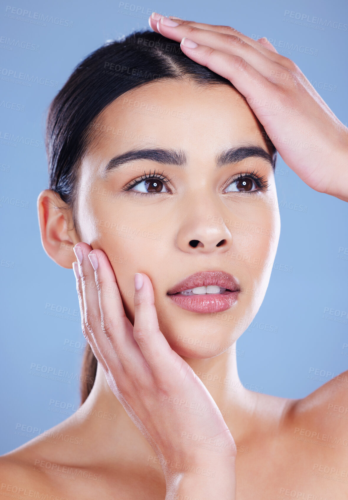 Buy stock photo Woman, thinking and hands in studio for skincare, cosmetics planning and touch on blue background. Female person, ponder facial treatment and transformation, dermatology and self care aesthetic