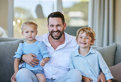 Buy stock photo Cropped portrait of a handsome mature man sitting on the sofa at home with his son and daughter