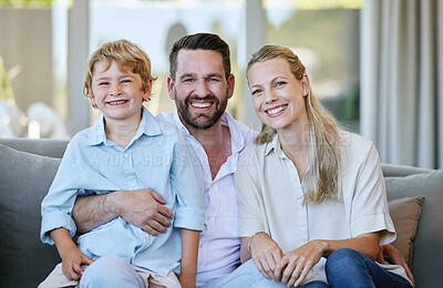 Buy stock photo Cropped portrait of an affectionate mature couple and their son sitting on the sofa at home