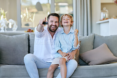 Buy stock photo Cropped portrait of a handsome mature man and his son cheering while watching TV in the living room at home