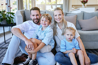 Buy stock photo Cropped portrait of an affectionate mature couple and their kids sitting in the living room at home
