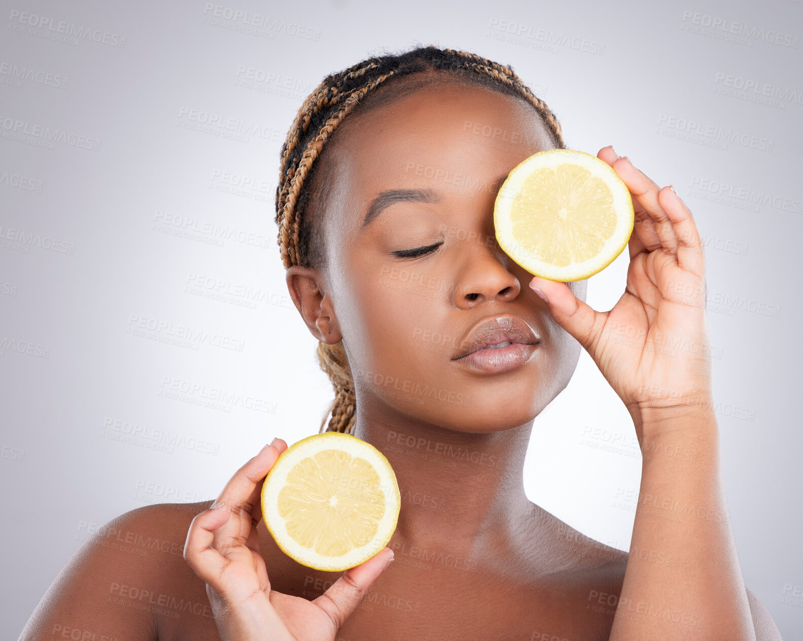 Buy stock photo Beauty, lemon and skincare with black woman in studio for natural, cosmetics and vitamin c. Nutrition, diet and detox with face of female model on grey background for citrus fruit and health product