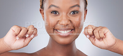 Buy stock photo Woman, portrait and floss for teeth in studio with smile for oral hygiene, dental care and gum disease. Black person, morning routine and cleaning mouth for fresh breath and plaque on gray background