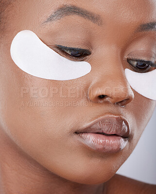 Buy stock photo Skincare, studio and black woman with patch on eyes for natural beauty, healthy skin or luxury cosmetics on face. Dermatology, thinking and girl with collagen mask, facial care and retinol treatment