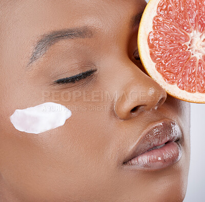 Buy stock photo Face cream, skincare and black woman with grapefruit in studio for beauty, cosmetics and facial. Dermatology, fruit and person with moisturizer for vitamins, wellness or nutrition with closeup