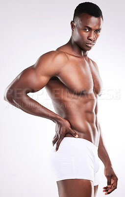 Buy stock photo Portrait of a handsome young man posing shirtless against a white background