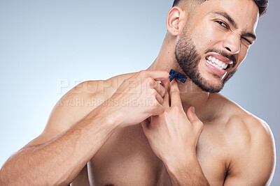 Buy stock photo Man, razor and pain for shaving in studio with grooming accident and facial transformation fail. Male person, blade tools and injury from hair removal and skin inflammation problem by gray background