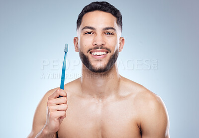 Buy stock photo Man, portrait and smile with toothbrush in studio for oral hygiene, mouth cleaning and morning routine on mockup. Dental, person and happy for fresh breath, plaque and healthy gyms on gray background