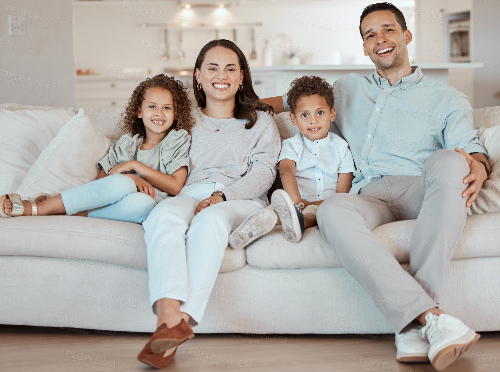 Buy stock photo Parents, happy family and portrait of children in home together for care, love and bonding. Smile, mother and father with kids on sofa in living room for support, laughing and relax with siblings