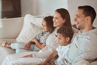 Buy stock photo Shot of a young family watching tv together at home