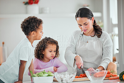 Buy stock photo Shot of a young family cooking food at home