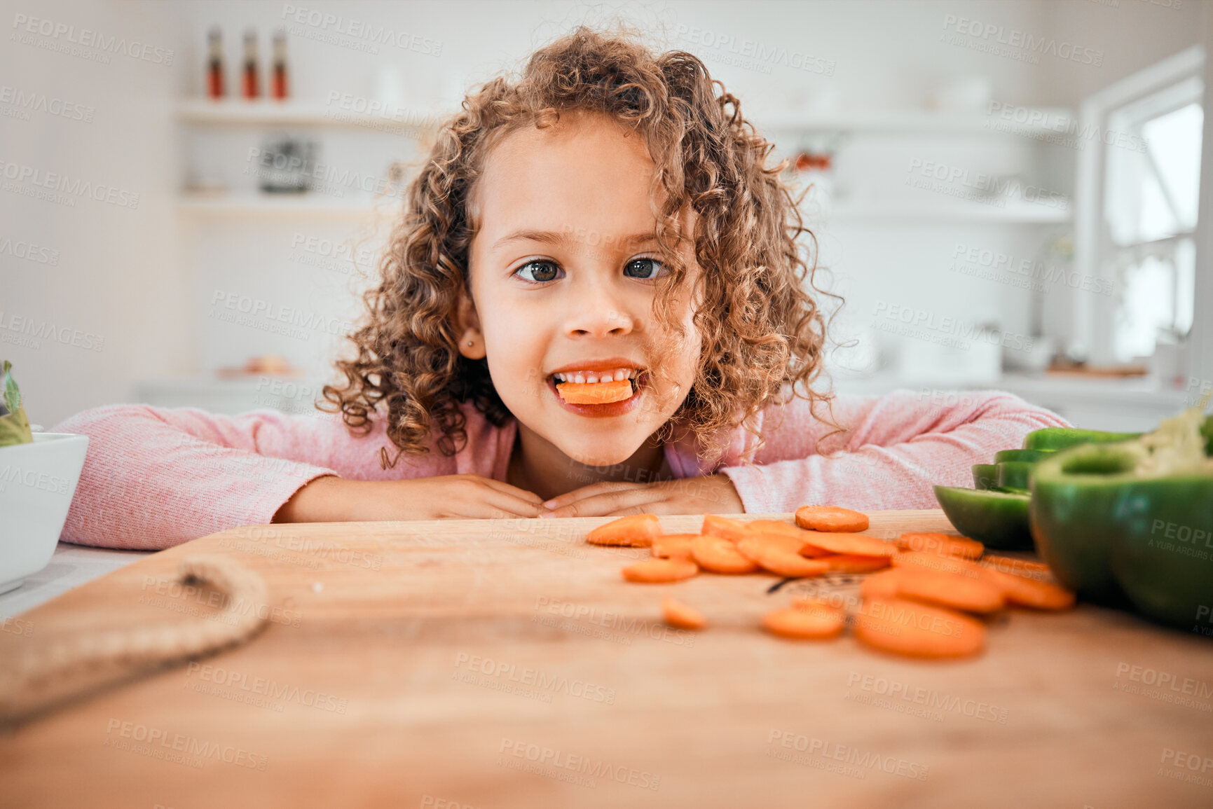 Buy stock photo Silly girl, portrait and eating carrots for healthy snack, meal or natural nutrition in kitchen at home. Young female person, child or kid with goofy face for vegetarian or vegan food at house