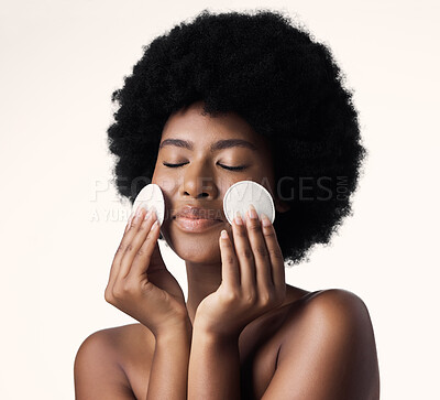 Buy stock photo African woman, skincare and cotton pad in studio with afro, face and cosmetics with product by background. Girl, model and happy for natural self care with makeup, eyes closed and cleaning for beauty