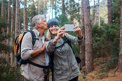 Buy stock photo Elderly, couple take selfie and hiking in forest, happy people in nature and memory for social media post. Smile in picture, adventure and fitness, old man and woman are outdoor with active lifestyle