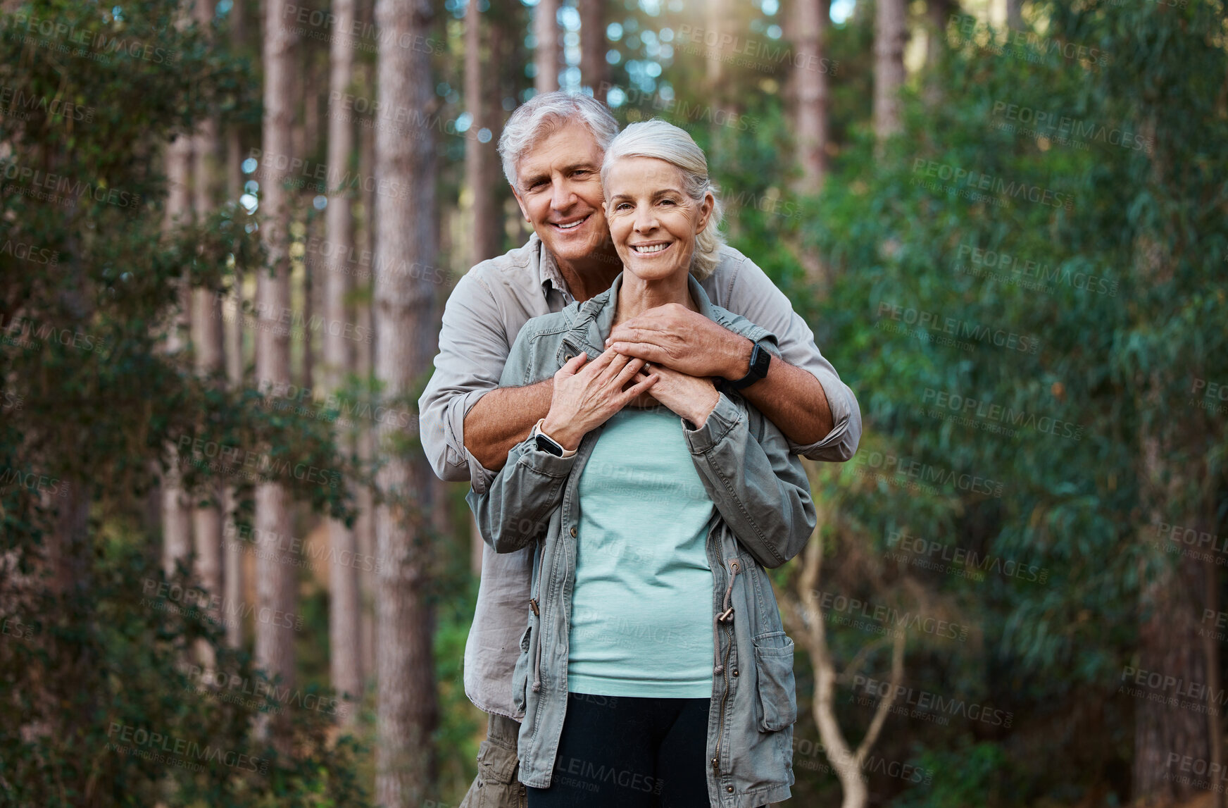 Buy stock photo Forest, portrait and senior couple hug for love, retirement wellness and health in nature hiking or travel. Face of happy mature woman and partner or people together in woods, park or countryside 