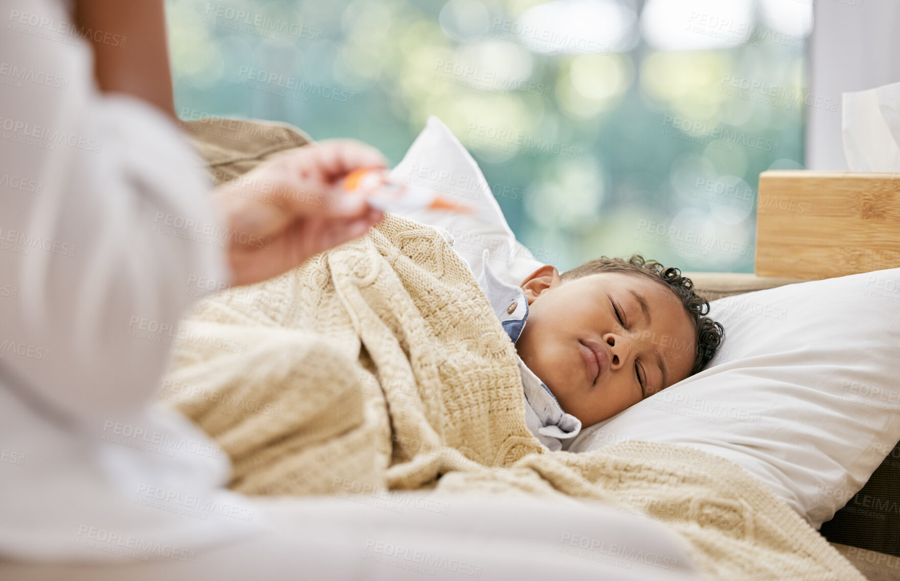 Buy stock photo Shot of a woman checking her son's temperature