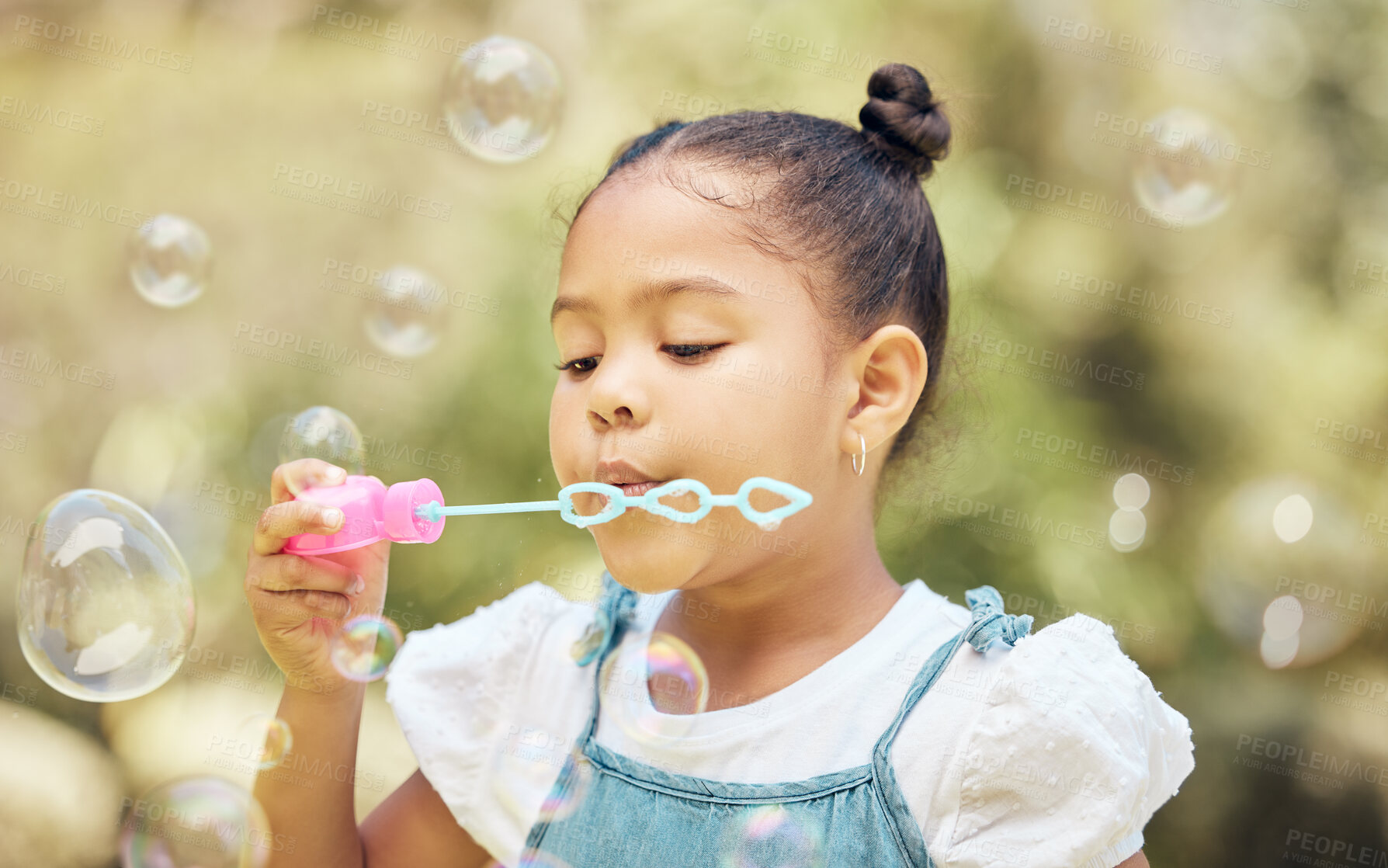 Buy stock photo Child, girl and blowing bubbles in outdoor park for playing, development or activity. Summer, freedom and young kid with soap toy for entertainment, having fun or enjoyment on weekend in backyard