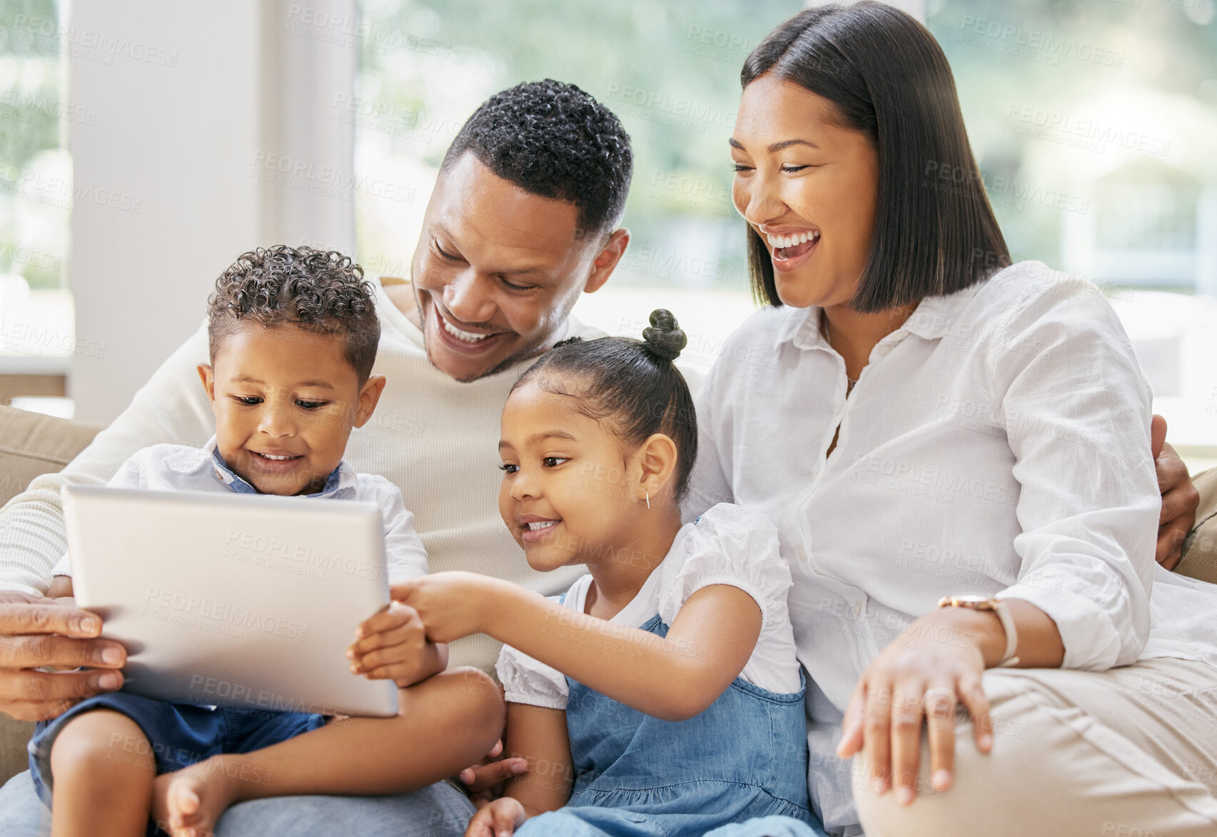 Buy stock photo Shot of a family using a tablet at home