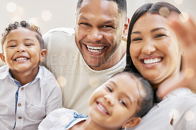 Buy stock photo Shot of a young family happily bonding together on the sofa at home