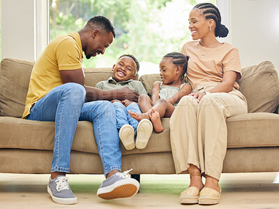 Buy stock photo Tickling, laughing and black family with children on home sofa for happiness, love and care. African kids, man and a woman or parents together on couch for fun, quality time and bonding while playing
