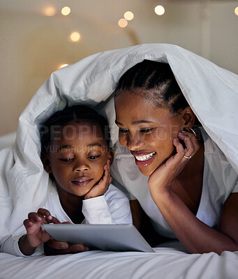 Buy stock photo Black family, movie and tablet in home at night, online and app for playing games for love. Mother, daughter and blanket for fort or watching cartoon in bedroom, streaming and rest together in bed