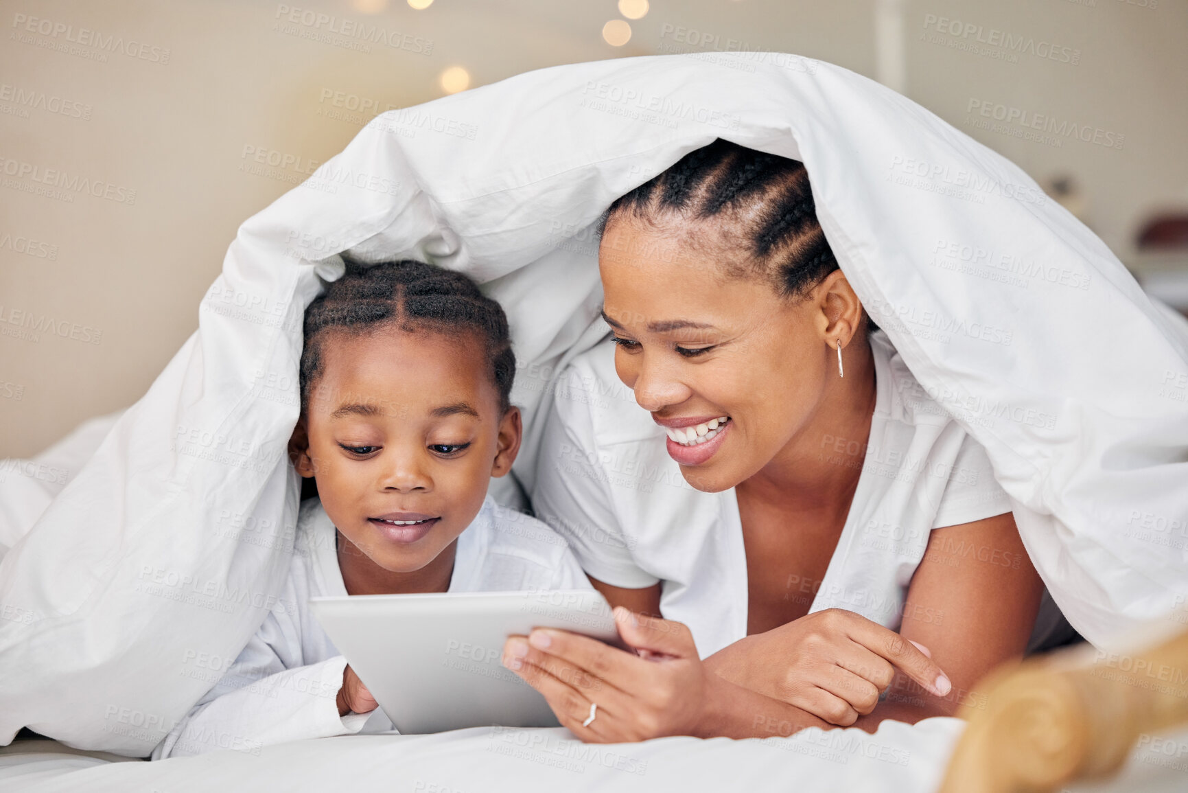 Buy stock photo Black family, blanket and tablet to relax in home, online and security in relationship or love. Mother, daughter and duvet for fort or watching cartoon in bedroom, streaming and rest together in bed