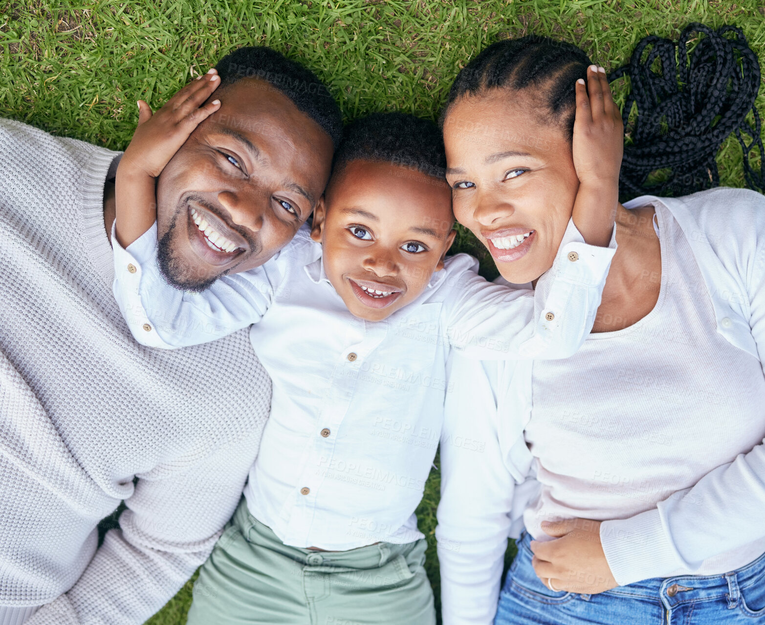 Buy stock photo Black family, together and above with portrait in outdoor for bonding, smile in park for vacation. Man, woman and son on lawn with happiness on holiday, solidarity and security in London with love