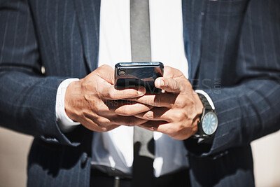 Buy stock photo Cropped shot of an unrecognizable businessman sending a text message while out in the city