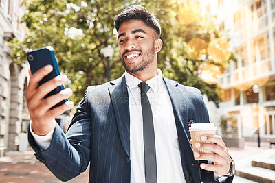 Buy stock photo Cropped shot of a handsome young businessman sending a text message while out in the city