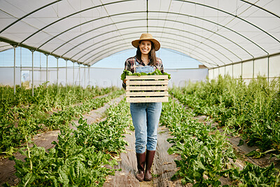 Buy stock photo Shot of a young farmer holding a crate of freshly harvested produce