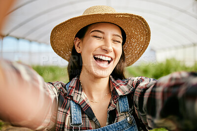 Buy stock photo Shot of a young female farmer taking selfies