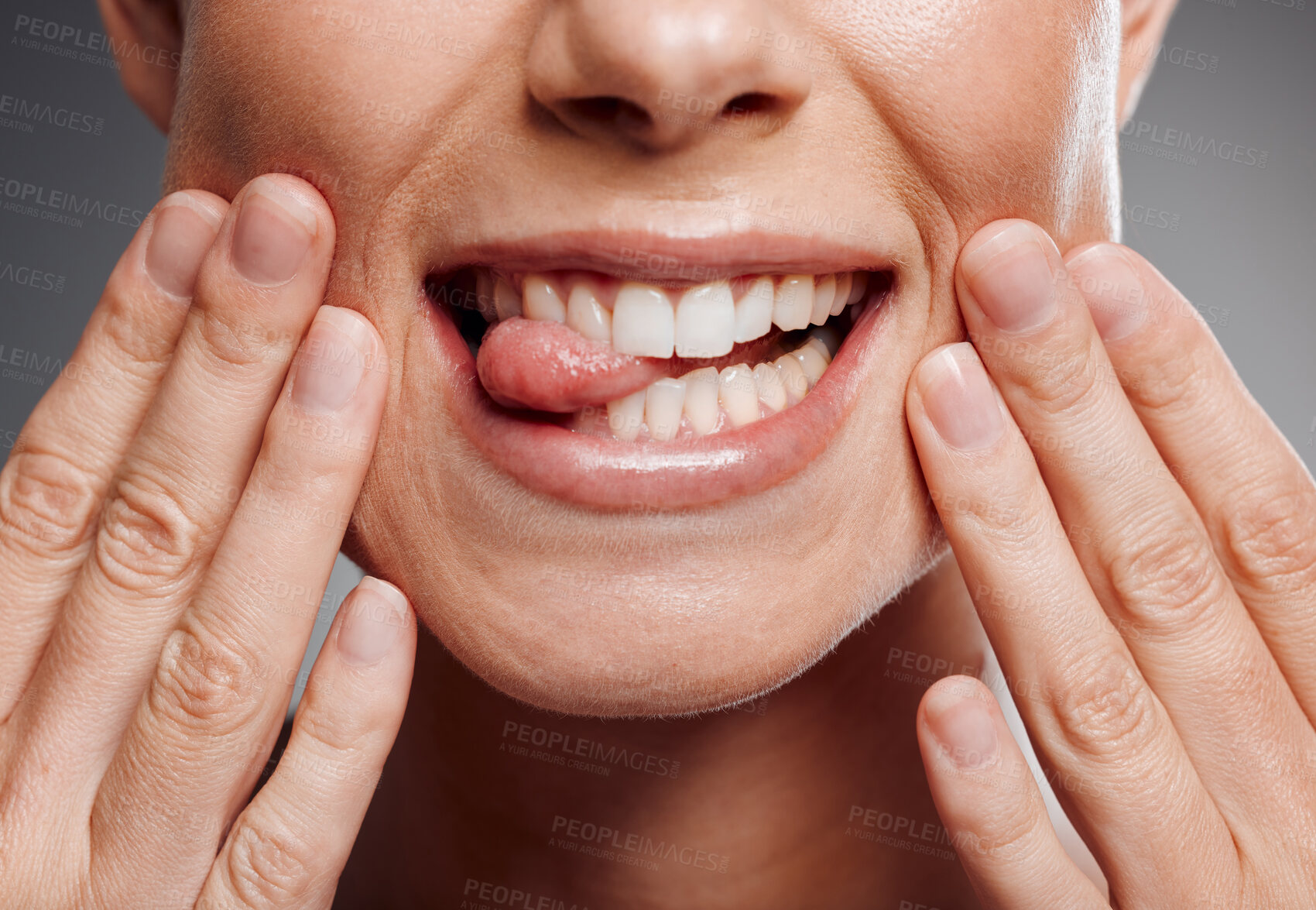 Buy stock photo Woman, mouth and teeth in studio with tongue out, dental cosmetics and beauty on gray background. Female person, hygiene treatment and grooming for oral health, orthodontics and cleaning closeup