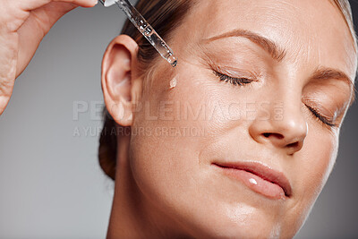Buy stock photo Beautiful mature woman posing with beauty treatment in studio against a grey background