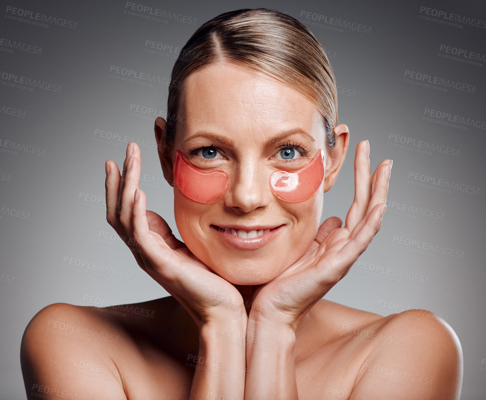 Buy stock photo Portrait, happy woman and eye patches for skincare, beauty and collagen treatment. Mask, mature model and cosmetics on face for dermatology, glow and shine for anti aging on gray studio background