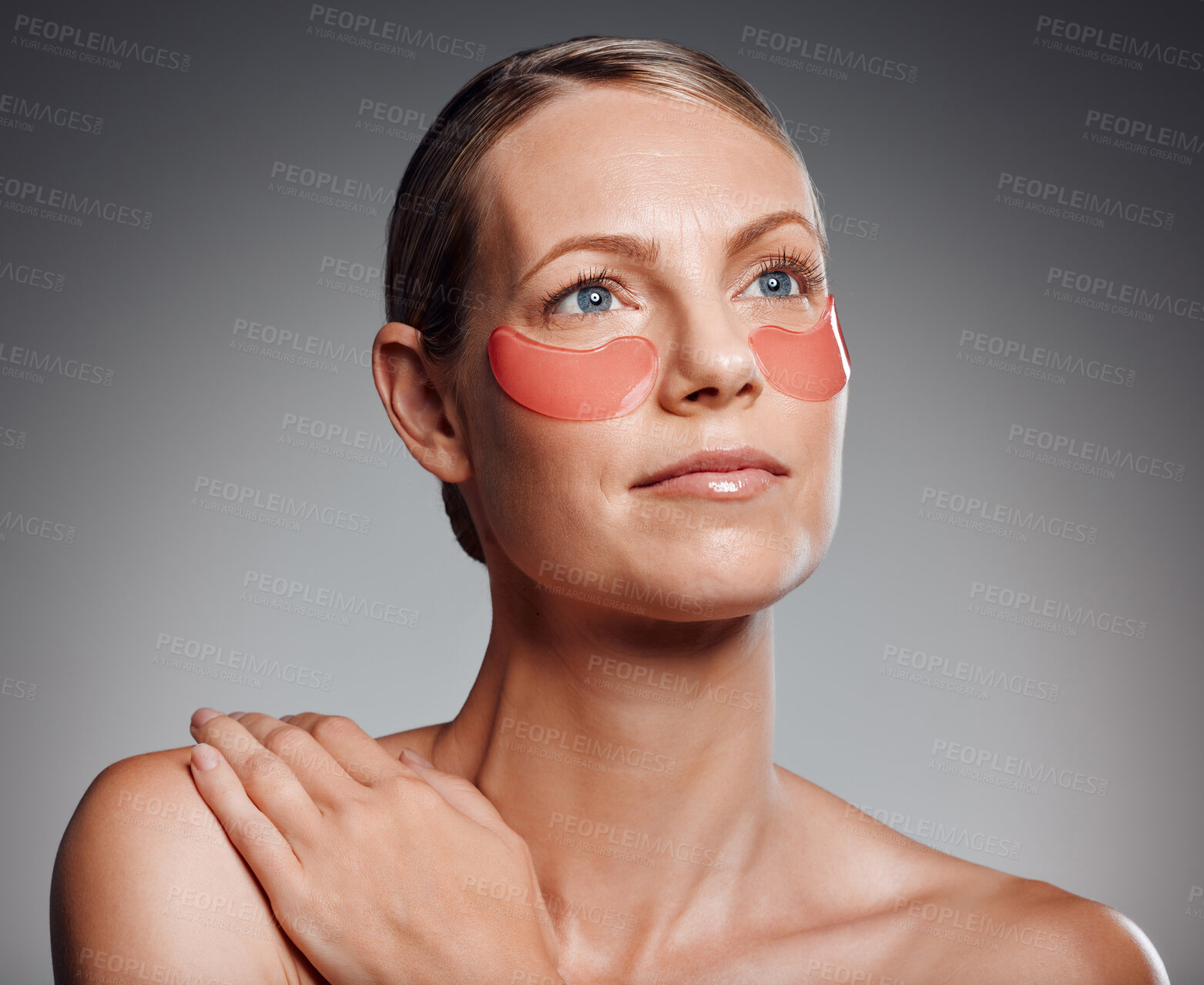 Buy stock photo Beauty, mature woman and eye mask for skincare, aesthetic or thinking of collagen treatment. Patches, model or cosmetics on face for dermatology, glow or anti aging isolated on gray studio background