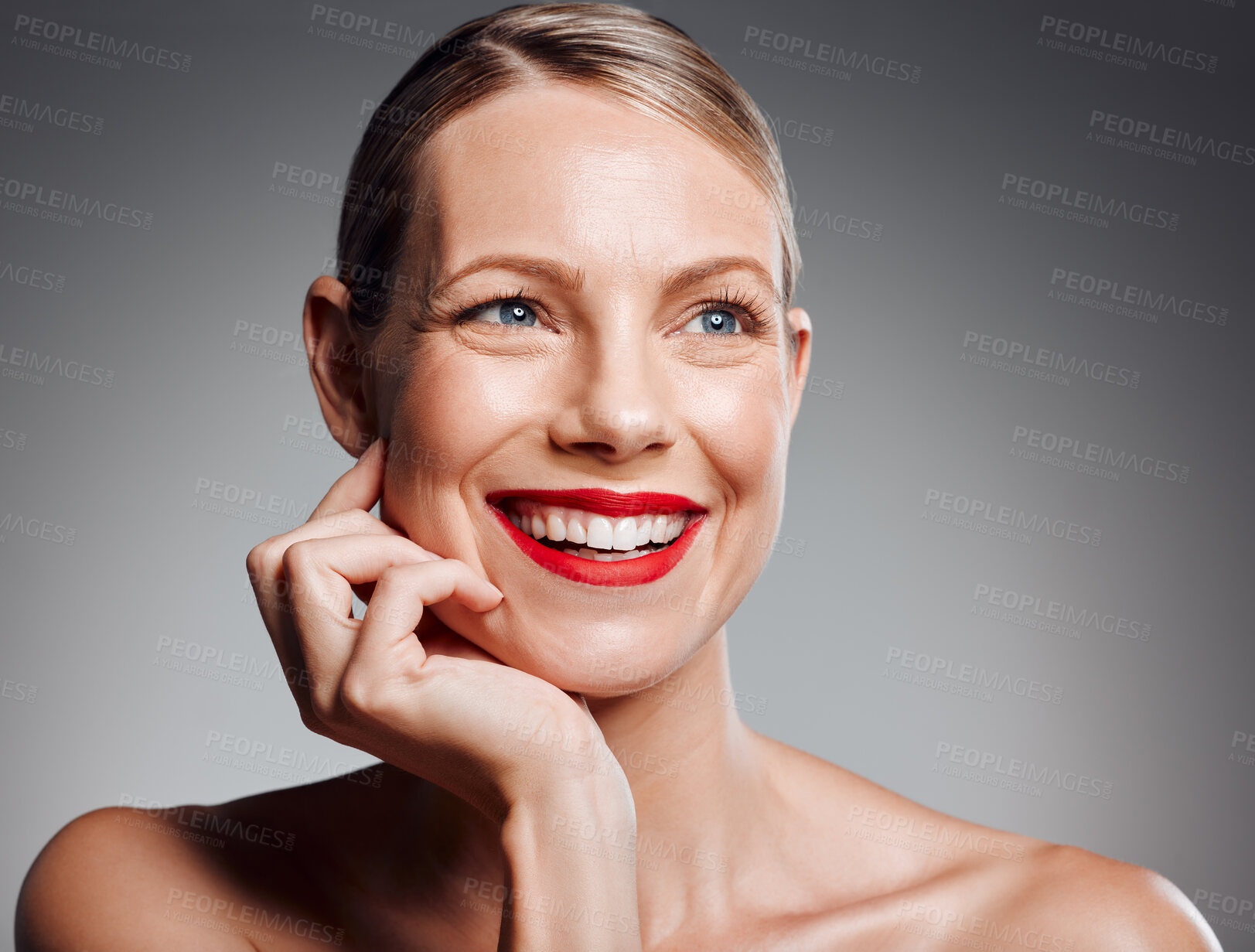 Buy stock photo Thinking, smile and mature woman with makeup for glow, beauty results and hand on gray studio background. Face touch, skincare and happy model in red lipstick for cosmetics, dermatology or anti aging