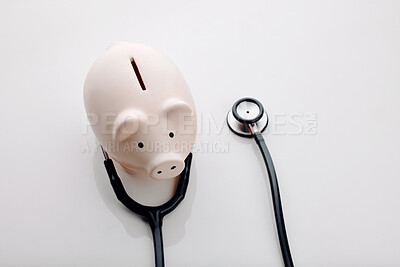 Buy stock photo Piggy bank, stethoscope for health insurance, investment and wellness in healthcare or medical aid. Background, budget and finance for retirement, pension and profit in saving, wealth and accounting