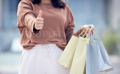 Buy stock photo Woman, shopping bag and hand with thumbs up in city for winning, discount or sale outdoors. Closeup of female person or shopper with thumb emoji, yes sign or like for luxury gifts or products in town