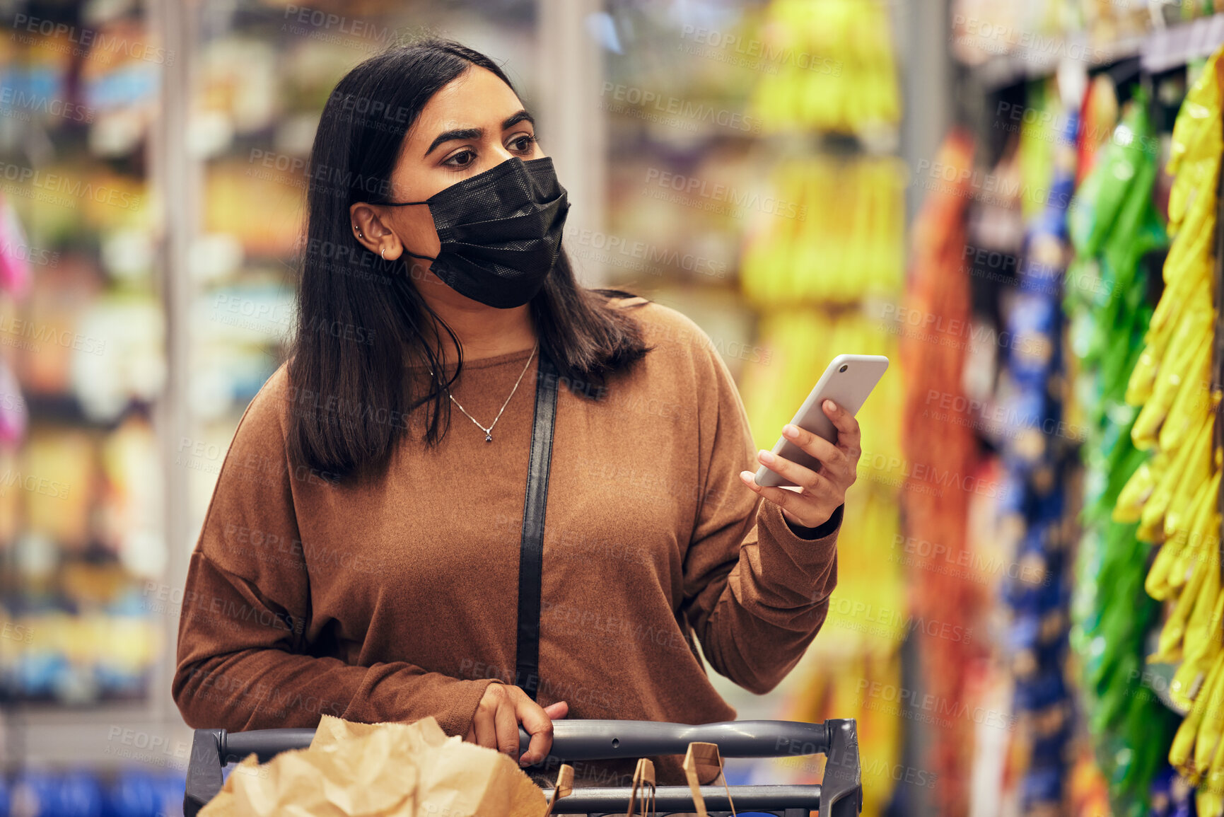 Buy stock photo Woman, phone and grocery checklist in shopping for food, luxury or product with face mask at supermarket. Female person or customer with mobile smartphone app for ingredient or groceries at store