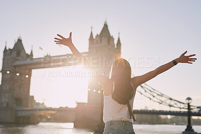 Buy stock photo Woman, freedom and travel by the London bridge or city for holiday break or outdoor summer vacation. Joyful female tourist with open arms enjoying sunny adventure trip, traveling and sightseeing