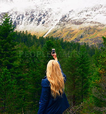 Buy stock photo Forest, woman and photography for snow in mountain on hiking adventure for memories in Canada. Back view, female person and tourist in woods for winter holiday, social media post and traveling