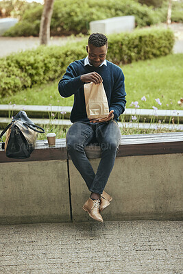 Businessman outside during his lunch break. Man taking a break from the office. Man opening his lunch