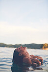 Sexy young woman swimming in the sea. Enjoying a summer vacation and relaxing weekend