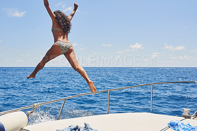 Buy stock photo Full length shot of an unrecognisable woman jumping off a boat during her holiday in Italy
