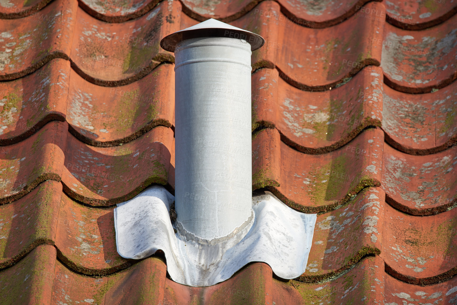 Buy stock photo Closeup shot of a white steel chimney on an old brown tile roof outside. Stay warm this winter with a fireplace. Light a fire and get rid of the smoke quickly and conveniently. Every home needs one