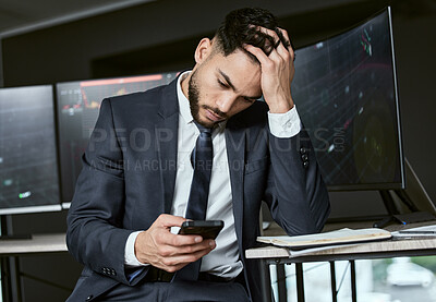 Buy stock photo Stressed businessman using a smartphone, trading on the stock market in a financial crisis. Trader working online in a bear market with stocks crashing. Market crash and economy depression or failure