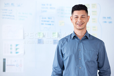 Portrait of smiling mixed race businessman standing alone in an office. Happy hispanic professional feeling confident after using a whiteboard to brainstorm a strategy. Leading in business by planning