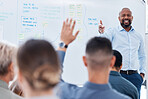 Mature african american business manager training and teaching team of colleagues in office. Black businessman using a whiteboard to talk and explain to diverse group of business people in workshop